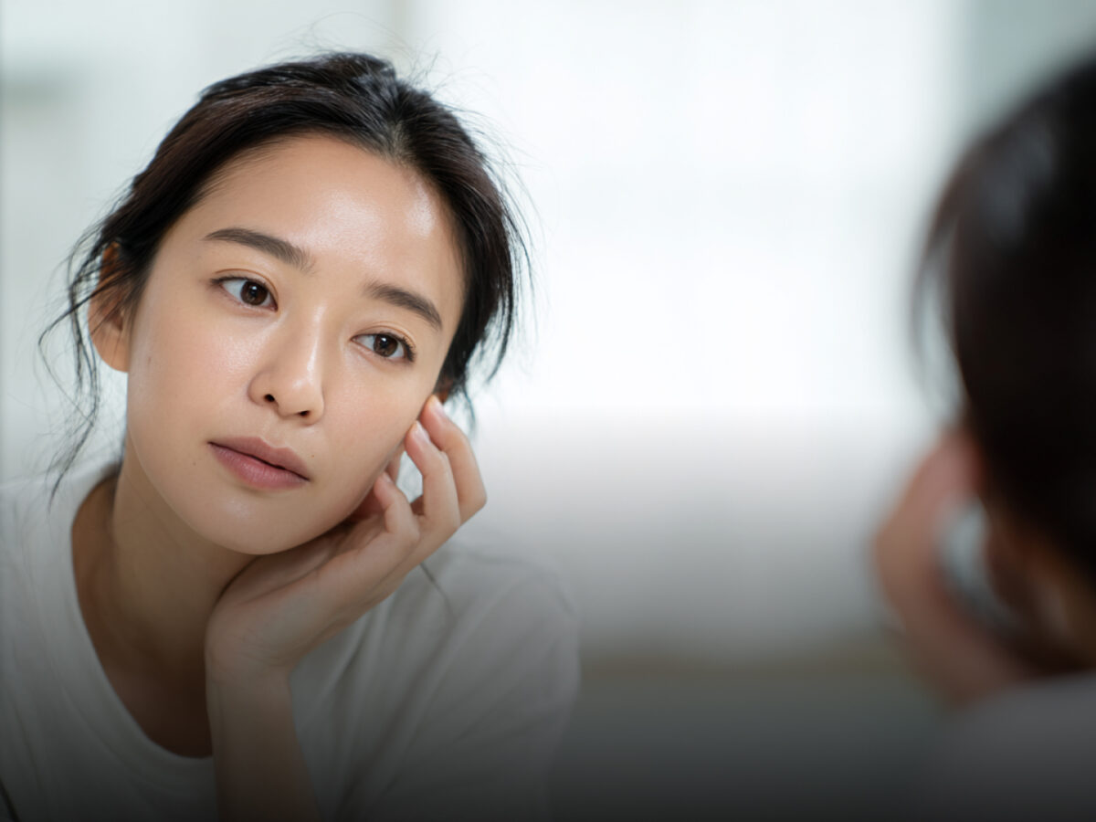 거울을 보고 스킨케어하는 여자